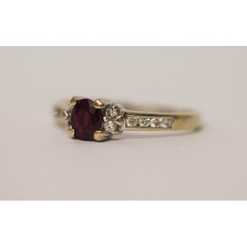 528 - 18ct ruby and diamond ring, claw set oval ruby of good colour on diamond shoulders, hallmarked, ring... 