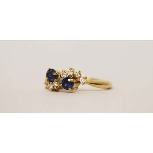 547 - Sapphire two stone ring, claw set with two circular sapphires of good colour, nine brilliant cut dia... 