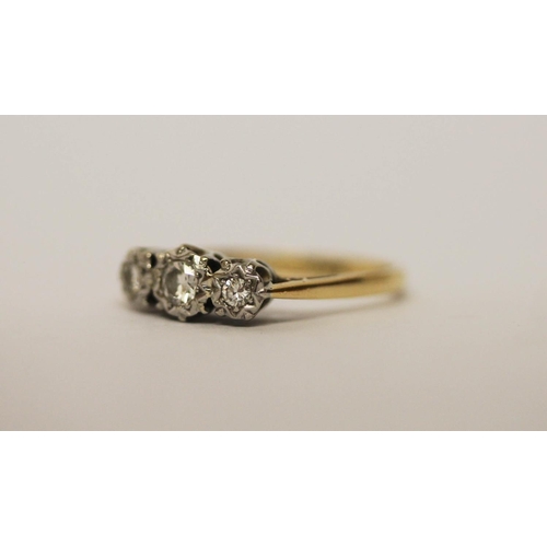 583 - A vintage three stone diamond ring, on 18ct gold and platinum band, ring size L, weight 2.5g