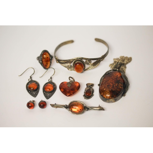 590 - A collection of silver and amber jewellery- bangle, large oval pendant pierced earrings etc