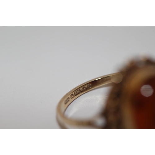 597 - A large oval amber dress ring on 9ct yellow gold band, size O,  and a 9ct gold sapphire and diamond ... 