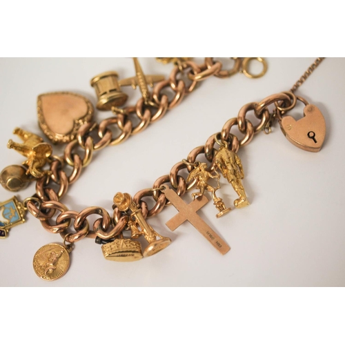 599 - A rose gold charm bracelet, the 9ct curb chain set with 12 hallmarked 9ct gold charms and a gold fro... 