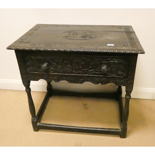 392 - A late Victorian carved dark oak hall table fitted one long drawer, standing on turned legs and stre... 