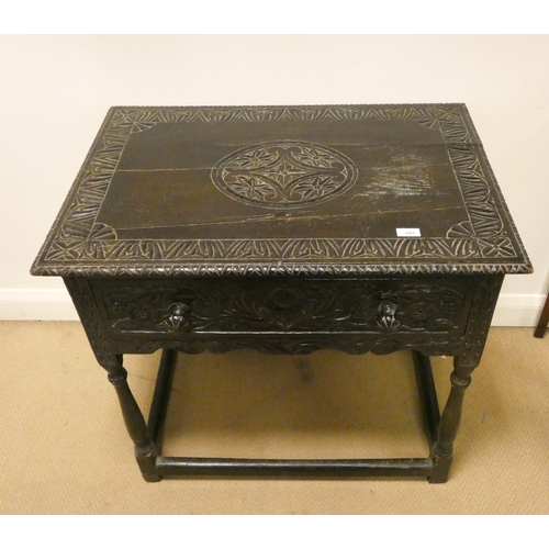 392 - A late Victorian carved dark oak hall table fitted one long drawer, standing on turned legs and stre... 