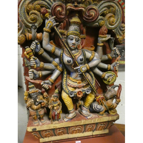 417 - A carved and polychrome painted Indian temple depiction of a Dancing Deity - possibly Durga, on a la... 