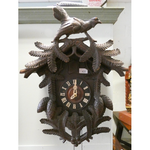 425 - A carved Black Forest Cuckoo clock with pendulum and weight