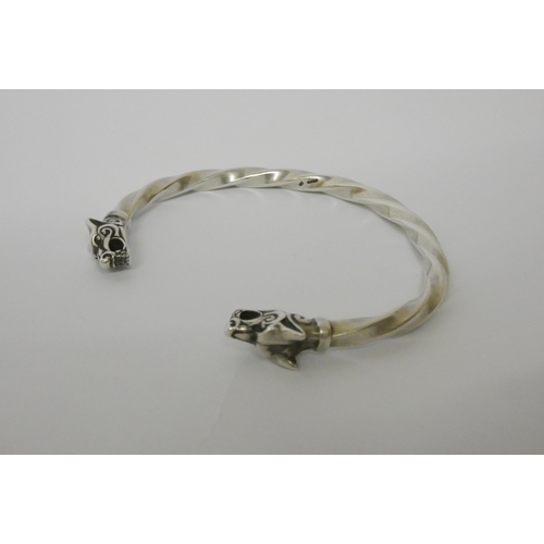 627 - A silver torque twist bangle with wolf head finials.