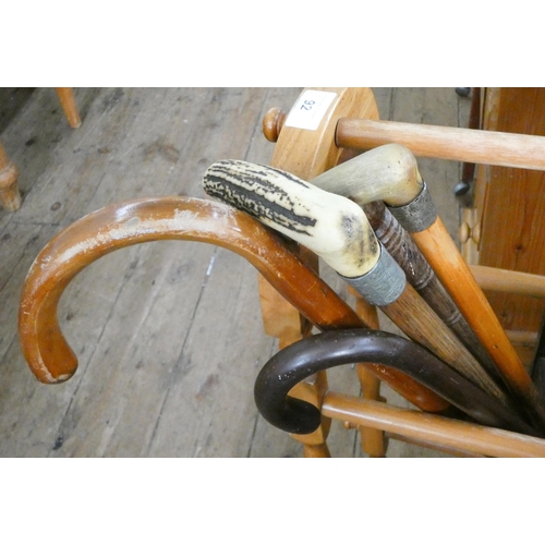 92 - A pine towel rail and five walking sticks (two have silver tops)