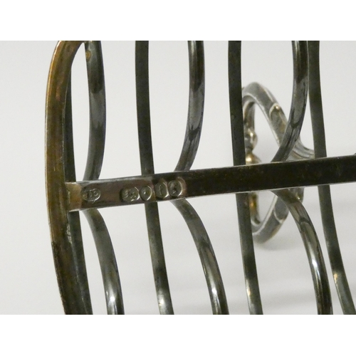 500 - A Victorian silver toast rack, London 1861 - John Evans. 17cms across, 8.1 troy ounces