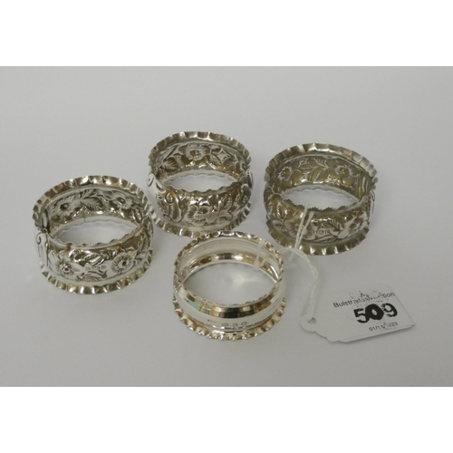 509 - Three matching silver napkin rings and a similar napkin ring.