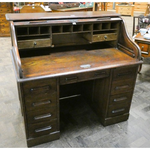 12 - An oak roll top desk with serpentine tambour front, stamped on the lock Globe Wernicke, 4' wide