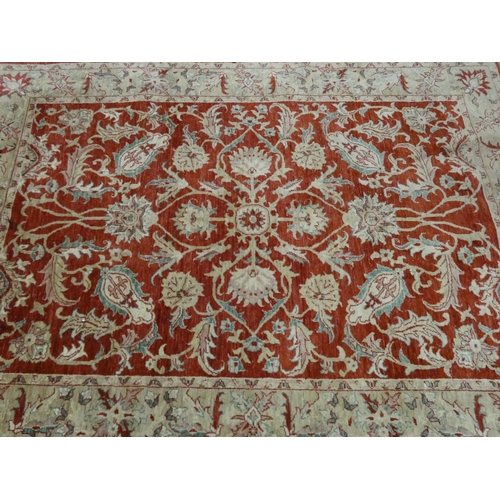 45 - A large red and cream patterned wool pile rug, 8'6 x 6'