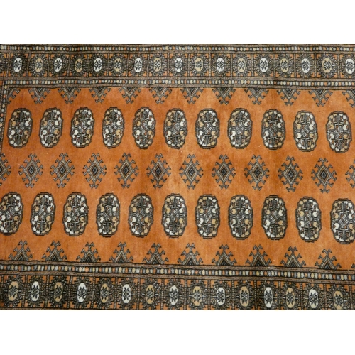 53 - A rust and Bokhara patterned rug, 5' x 3'