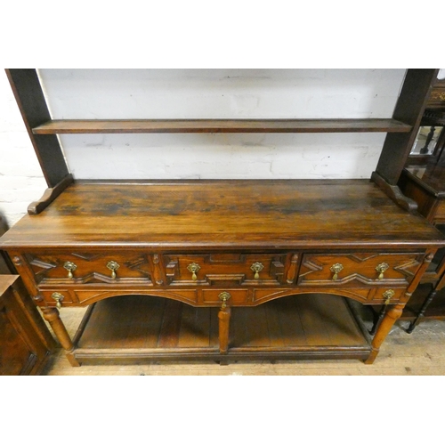 7 - An oak Welsh style dresser with open shelf back, fitted three drawers and pan rack under, 67