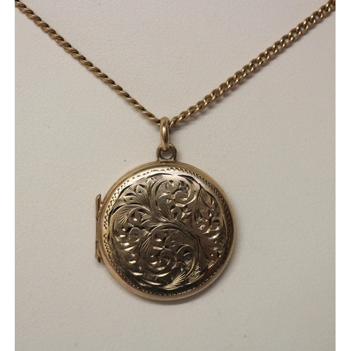 424 - A circular 9ct gold locket on long gold chain. Gross weight 9.4g