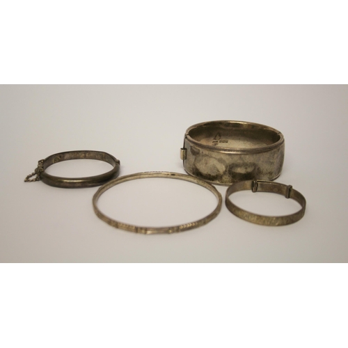 429 - Four silver bangles of various forms. 80 grams.