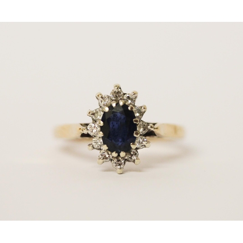 444 - A sapphire and diamond oval cluster ring, on hallmarked 9ct gold band. Ring size L