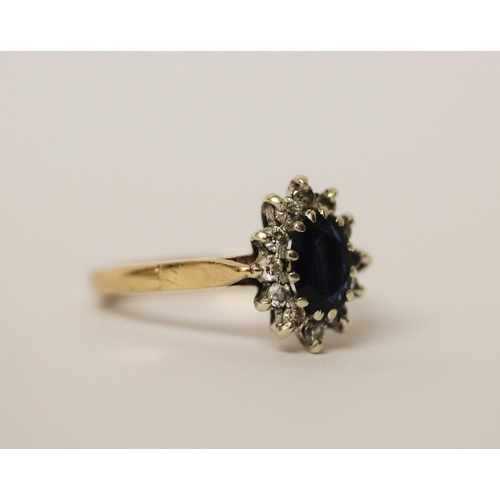 444 - A sapphire and diamond oval cluster ring, on hallmarked 9ct gold band. Ring size L