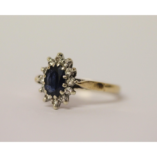 444 - A sapphire and diamond oval cluster ring, on hallmarked 9ct gold band. Ring size L