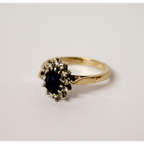 444 - A sapphire and diamond oval cluster ring, on hallmarked 9ct gold band. Ring size L