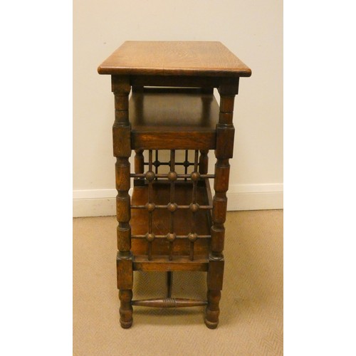 63 - An Arts & Crafts oak three tier side or occasional table with bobbin turned sides, 25