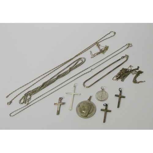 437 - Silver cross pendants, Our Lady pendant and a collection of silver chains.