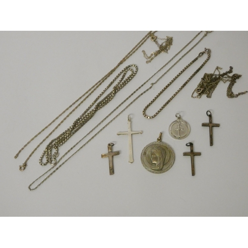 437 - Silver cross pendants, Our Lady pendant and a collection of silver chains.