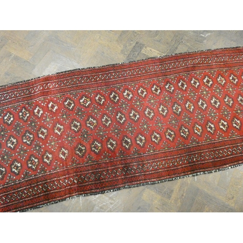 138 - A red and patterned Bokhara carpet runner, 8' X 3'10 approximately