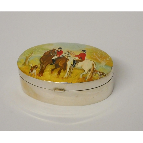 524 - A hallmarked silver oval snuff box, the hinged lid hand painted with hunting scene. 8cms across appr... 