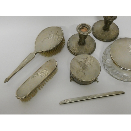 533 - A silver dressing table set - comprising pair of circular based candlesticks, a cut glass powder bow... 