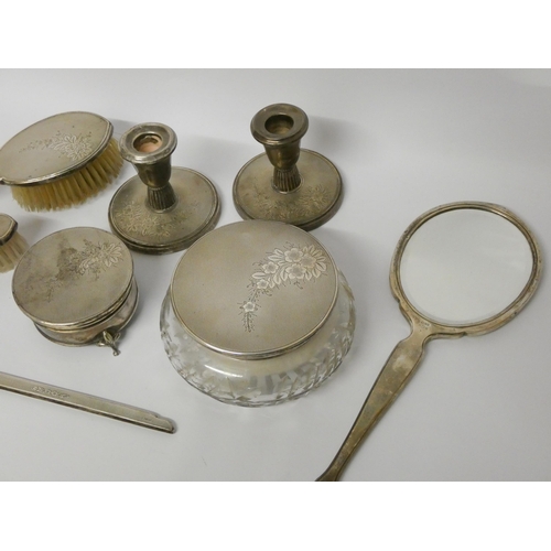 533 - A silver dressing table set - comprising pair of circular based candlesticks, a cut glass powder bow... 