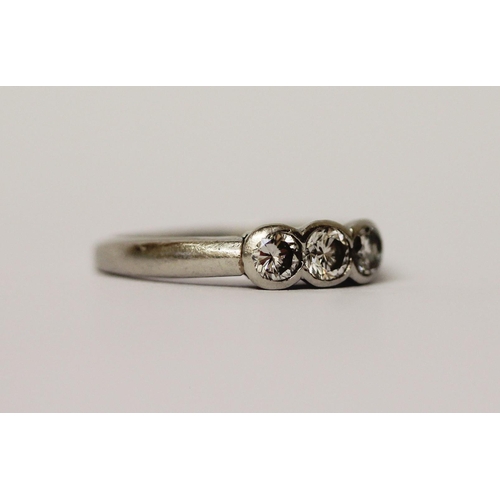 466 - A platinum and diamond three stone ring, hallmarked, ring size K, weight 4.4g