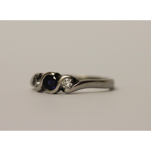 467 - A platinum set sapphire and diamond three stone ring, hallmarked, ring size L 1/2, weight 4.1g