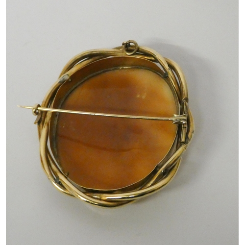 406 - Large oval carved shell cameo brooch in twisted gold frame, 65mm length