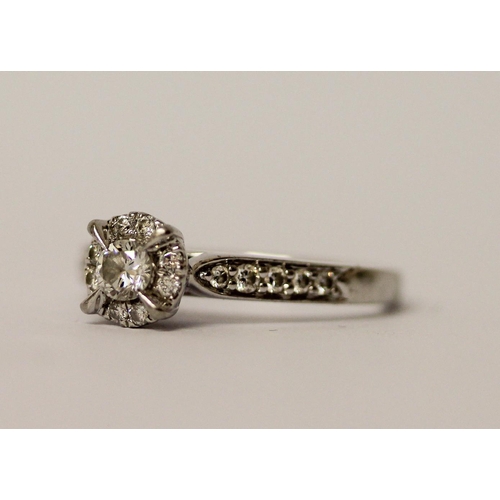 417 - Modern platinum diamond engagement ring with a central claw set brilliant cut diamond within halo se... 