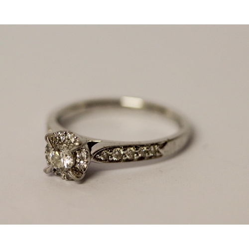 417 - Modern platinum diamond engagement ring with a central claw set brilliant cut diamond within halo se... 