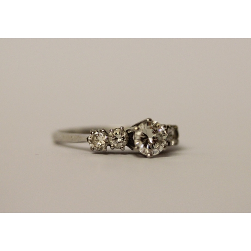 489 - A diamond ring, claw set circular brilliant cut diamond weighing 0.6cts, with further diamonds to th... 