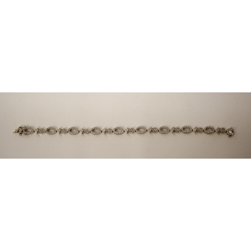 493 - Modern 18ct gold diamond bracelet, comprising alternate open and flower design links all set in 18ct... 