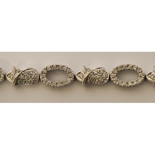 493 - Modern 18ct gold diamond bracelet, comprising alternate open and flower design links all set in 18ct... 