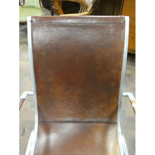 81 - A polished aluminium and brown leather designer elbow chair