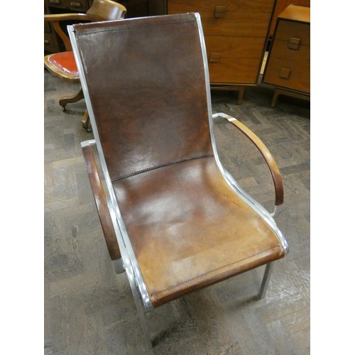 81 - A polished aluminium and brown leather designer elbow chair