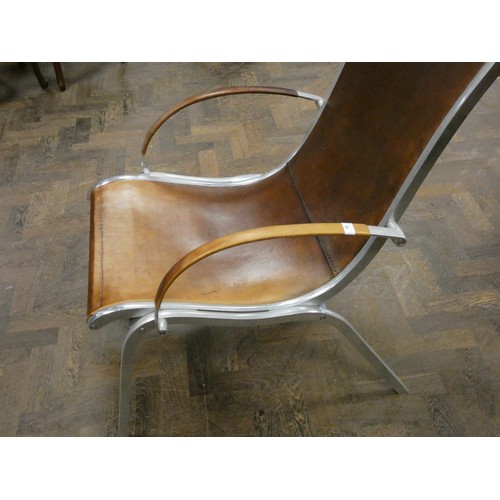 81 - A polished aluminium and brown leather designer elbow chair