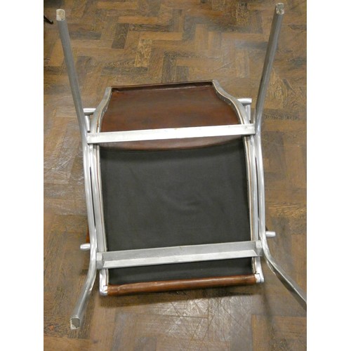 81 - A polished aluminium and brown leather designer elbow chair