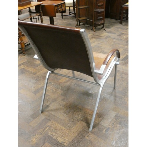 81 - A polished aluminium and brown leather designer elbow chair