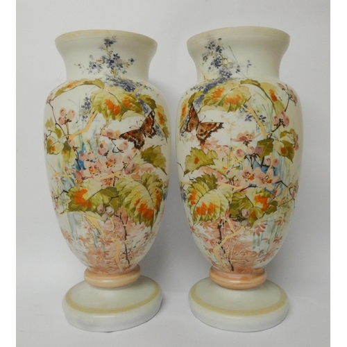 234 - A pair of late Victorian opaline glass vases, hand enamelled with flowers and butterflies, 37.5 cms ... 