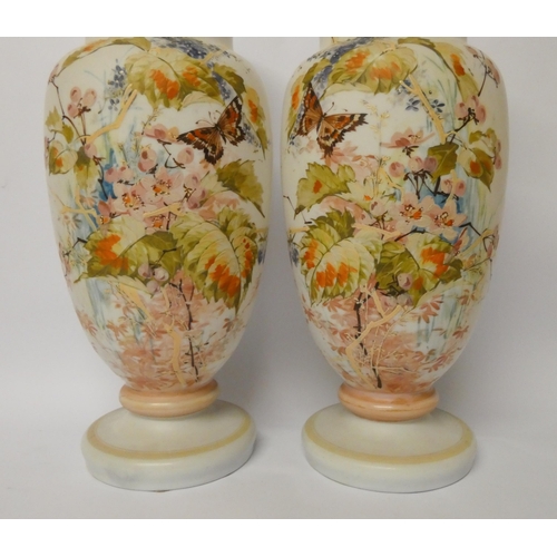 234 - A pair of late Victorian opaline glass vases, hand enamelled with flowers and butterflies, 37.5 cms ... 