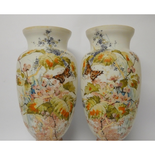 234 - A pair of late Victorian opaline glass vases, hand enamelled with flowers and butterflies, 37.5 cms ... 