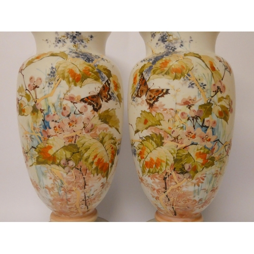 234 - A pair of late Victorian opaline glass vases, hand enamelled with flowers and butterflies, 37.5 cms ... 