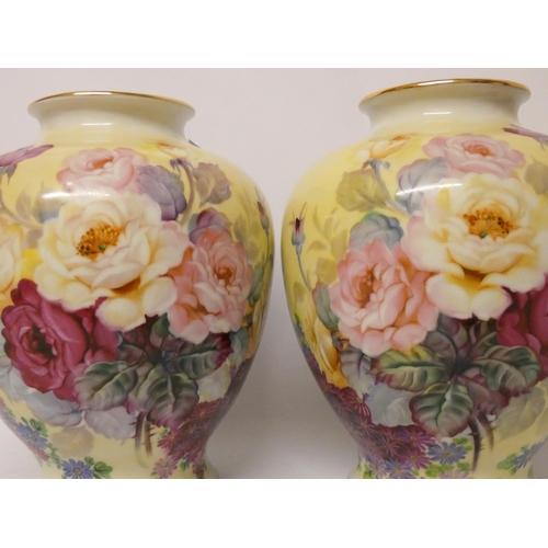 239 - A pair of Japanese hand painted bulbous vases decorated with roses and signed J Kato, 10