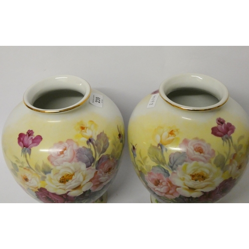 239 - A pair of Japanese hand painted bulbous vases decorated with roses and signed J Kato, 10